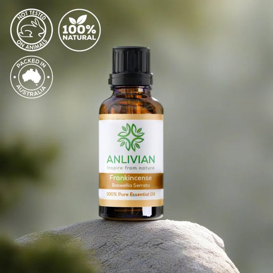 Anlivian frankincense essential oil bottle on a rock with nature background