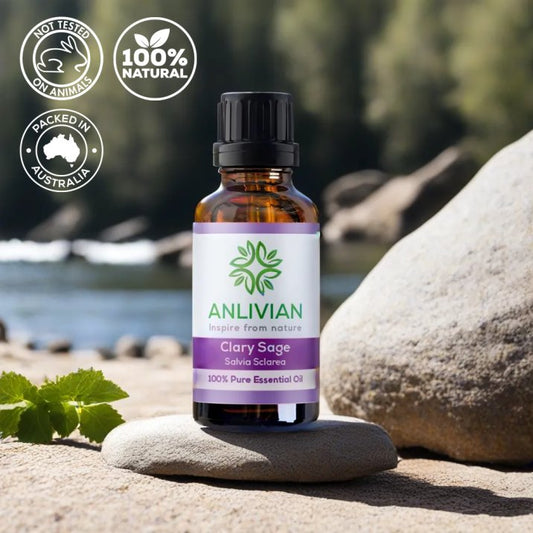 Anlivian Clary Sage Essential Oil bottle on a river rock with greenery. Icons confirm the product is Not Tested on Animals, 100% Natural, and Packed in Australia.